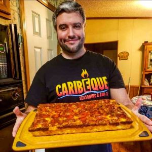 Troy Sparks of Grizzly BBQ with a pizza