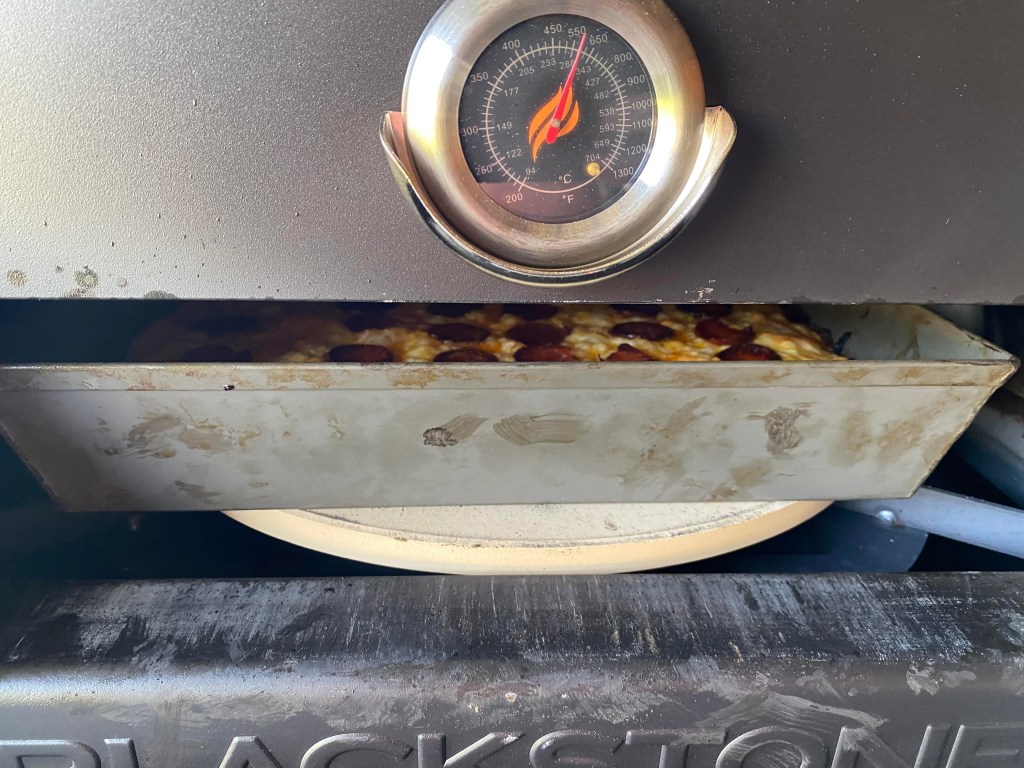 Detroit style pizza cooking away in the Blackstone Pizza Oven Conversion Kit