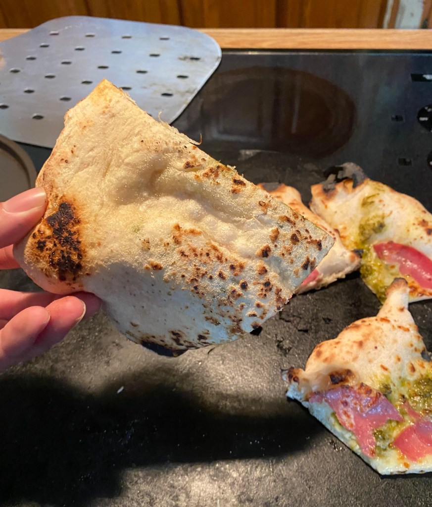 The undercarriage of the salami pizza with a pesto base that was cooked in the Stoke Pizza Oven.