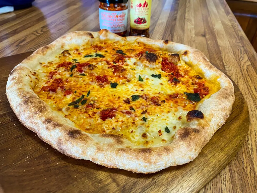 A Neo-Neapolitan pizza with Calabrian peppers and basil, baked in the Halo Versa 16 pizza oven